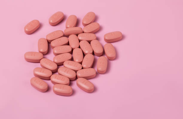 istock HIV/AIDS therapy pills on pink background 1214095667