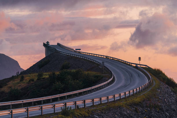 istock Car passing  on  Atlantic road  at sunset 1214096174