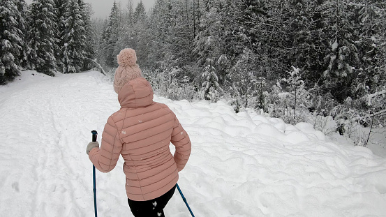 She walks along majestic looking winter trail