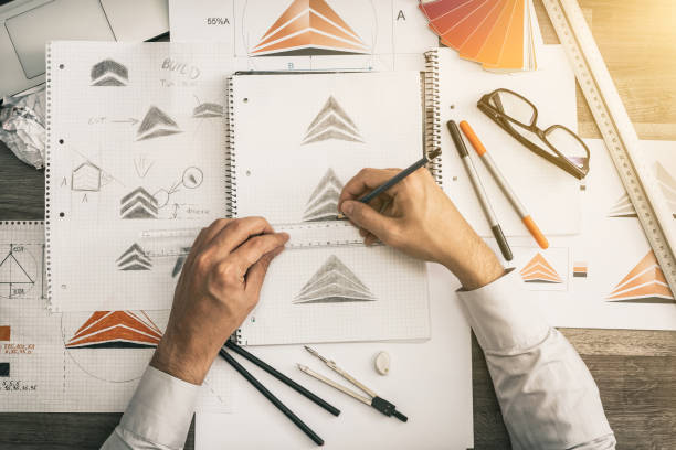 istock Graphic designer drawing sketches logo design. 1214096980
