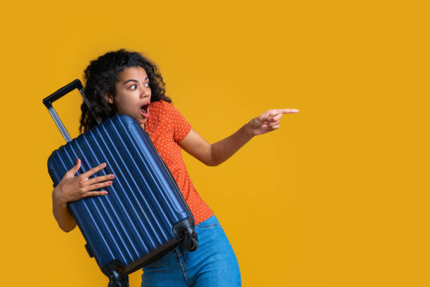 istock Beautiful dark skinned female tourist isolated on bright colored background 1214097078