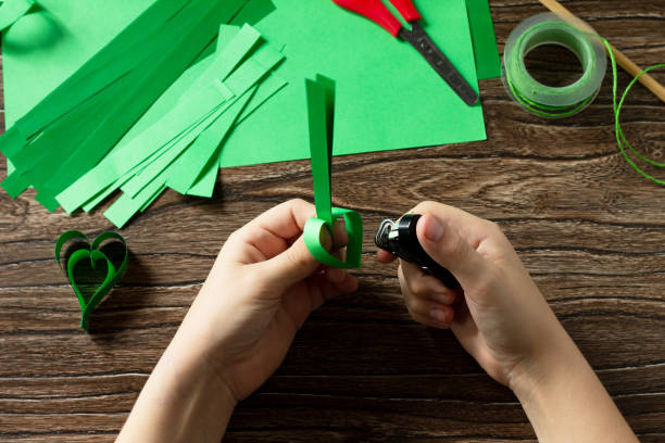 istock Instruction, step 5. St. Patrick's Day Clover, craft paper. Handmade. Children's art project, needlework, crafts for children. 1214097184