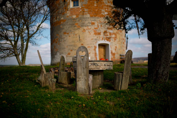 istock Picnic under a decorated deciduous tree in the background a stone windmill. Sunny autumn day. Czech Republic, Moravia 1214098265