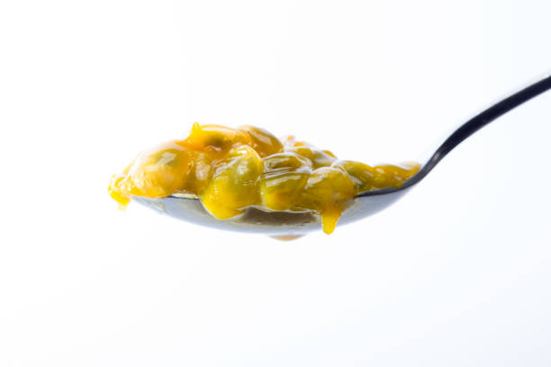 istock Spoon of juicy and exotic passion fruit pulp 1214099642