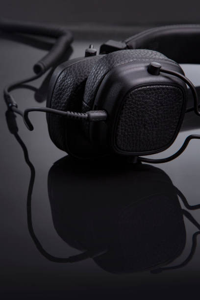 istock black headphones on a glossy table close-up 1214100832