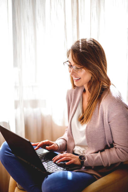 istock Beautiful young woman using laptop 1214102513