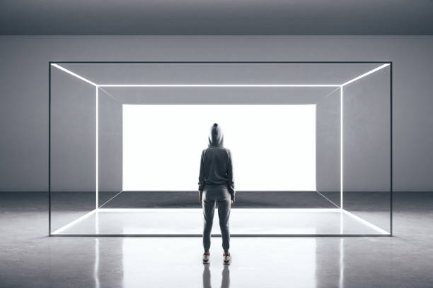 istock Hacker standing in futuristic gallery interior with glowing billboard 1214104364