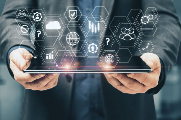 istock Businessman holding tablet with abstract global business interface 1214105319