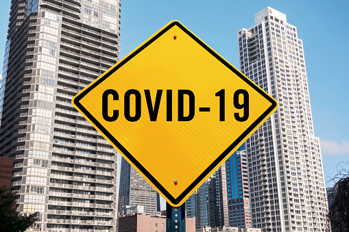 Covid-19 sign in front of Chicago downtown