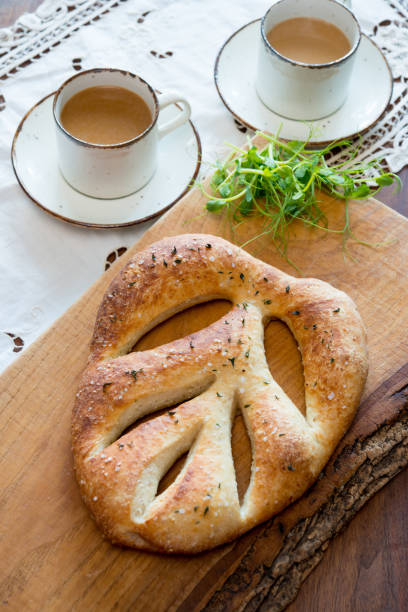 French fougasse bread on rustic oak wood board