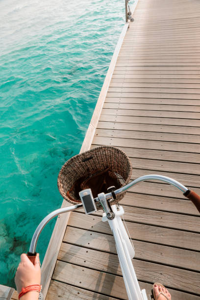 istock Riding a bicycle on maldives jetty 1214109446
