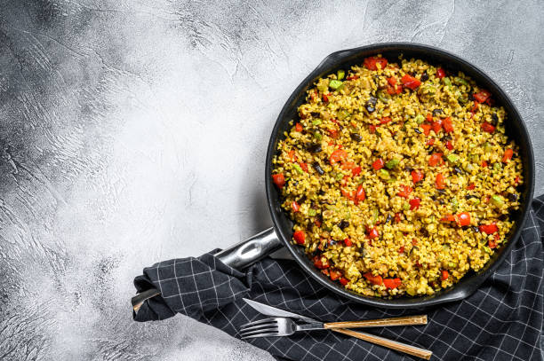 istock Cooked bulgur with vegetables in a pan. Gray background. Top view. Copy space 1214109541