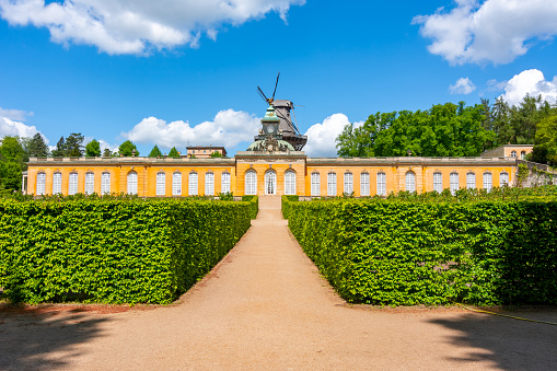 Potsdam, Germany - May 2019: New Chambers (Neue Kammern) palace and Windmill (Windmuhle) in Potsdam park