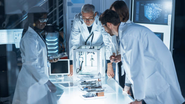 istock In Technology Research Laboratory: Diverse Team of Industrial Scientists, Engineers, Developers Work with Digital Whiteboard Showing Engine Blueprints, Efficiency Calculated by Neural Network 1214111369