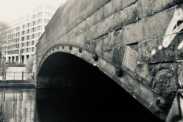 istock Curvy concrete footover bridge on a lake in Berlin 1214117694