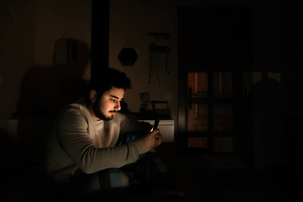 istock Young man in bed looking at his smartphone screen 1214120440