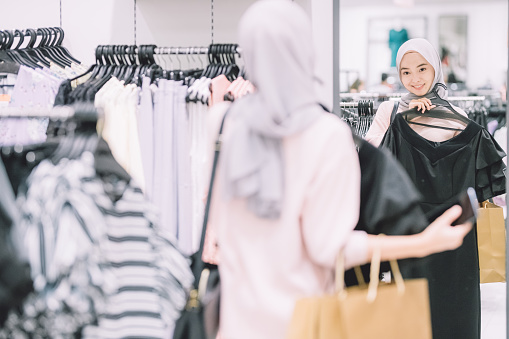 an asian malay muslim woman ramadan shopping for her clothes