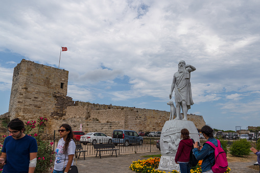 Sinop/Turkey - August 04 2019: Statue Of Diogenes, famous ancient Greek philosopher born in Sinop in the 5th century BC. Sinop fortress in background.