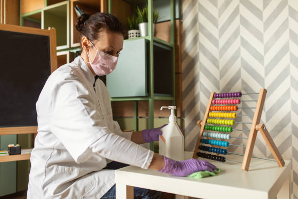 istock Female doctor cleaning kindergarten 1214120939
