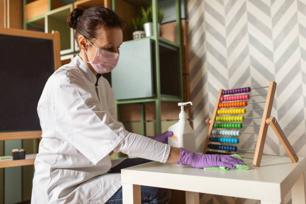 Female doctor cleaning kindergarten