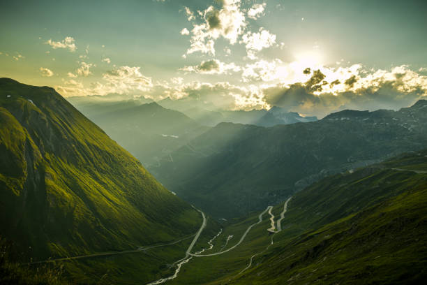 Evening mood on Furka high mountain pass with beautiful views on Alps Evening mood on Furka high mountain pass with beautiful views on surrounding Swiss Alps river valleys stock pictures, royalty-free photos & images