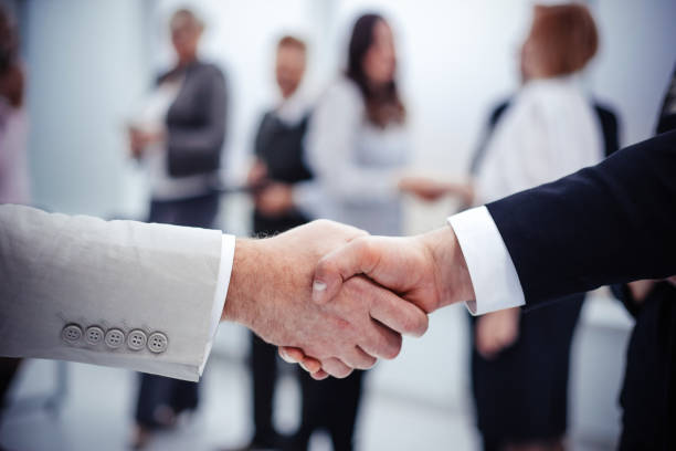 istock close up. business handshake on office background. 1214124344