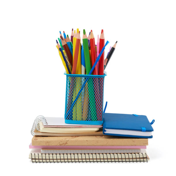 istock wooden multi-colored pencils, plastic pens and a stack of paper notebooks are isolated on a white background 1214126055