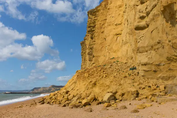 Rock fall sandstone cliff rocks Jurassic coast England UK near West Bay