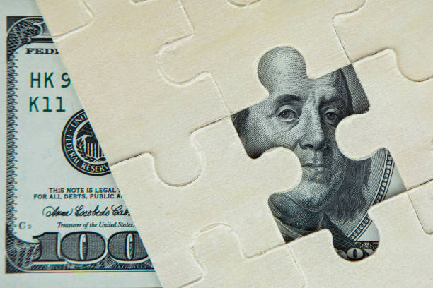 istock dollar and calculator on the table, financial crisis concept 1214127392