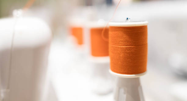 reels of thread on machine embroider on the table of new technology embroidering machine - embroider imagens e fotografias de stock