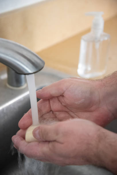 istock Man washing his hand with bar soap 1214134846