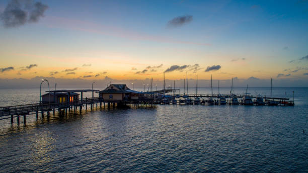 Fairhope Municipal Pier The Fairhope pier and Mobile Bay at sunset on the Alabama Gulf Coast mobile bay stock pictures, royalty-free photos & images