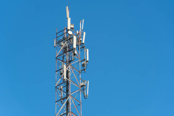 istock Mobile communication tower close-up against the blue sky, copy space 1214135291