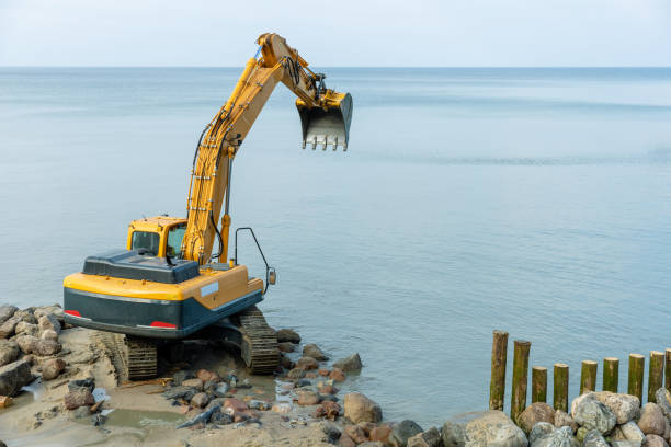 istock excavator on the beach, strengthening the beach and installing breakwaters 1214135946