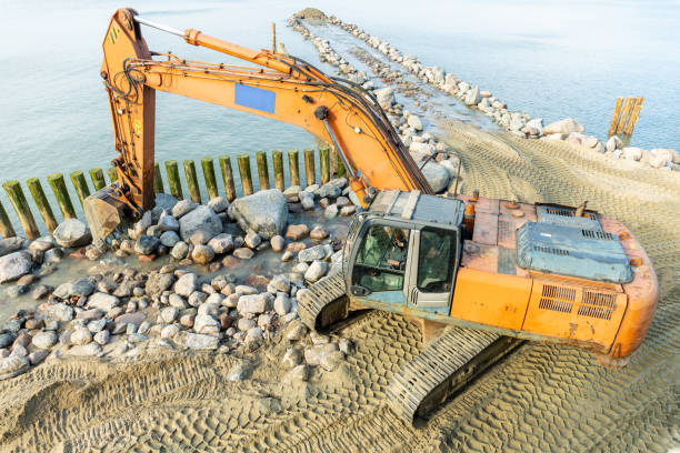 istock excavator on the beach, strengthening the beach and installing breakwaters 1214135969