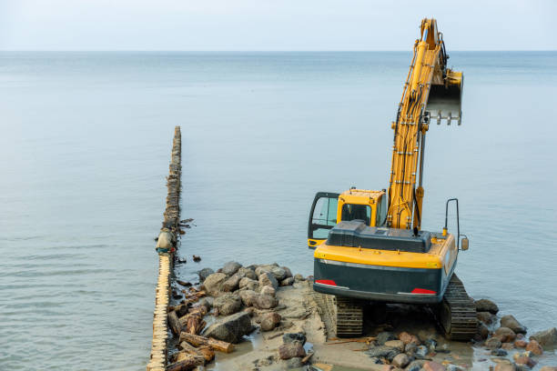 istock excavator on the beach, strengthening the beach and installing breakwaters 1214135999
