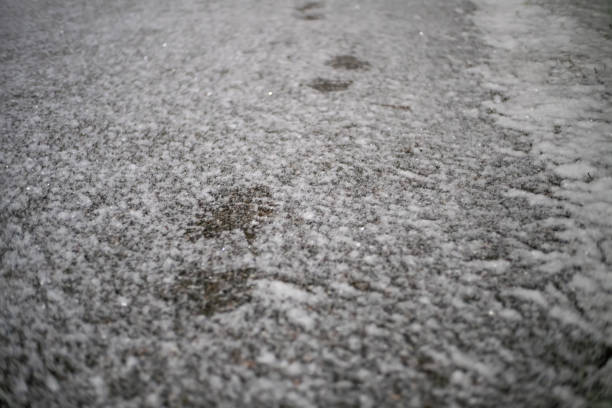 istock Fresh boot tracks on the snow -covered road in the evening 1214136063