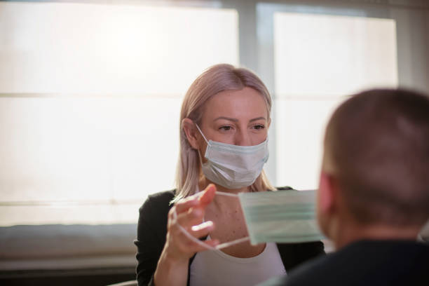 istock Mother and her son putting masks on protect themselves from viruses 1214137098