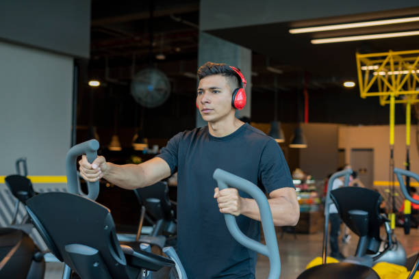 istock Latin man using dumbbell in the gym 1214137471