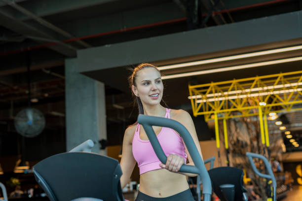 istock Latin woman using dumbbell in the gym 1214137739