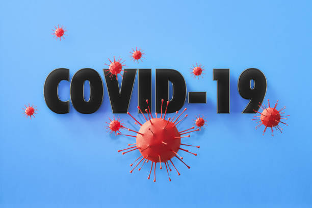 istock COVID-19 Text Surrounded by Red Viruses on Blue Background 1214137751