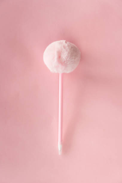 istock pink fluffy cute pen for note writing paper background 1214139427