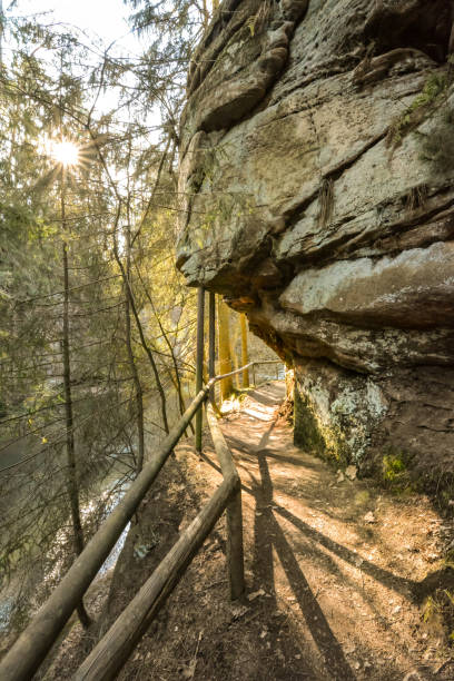 istock Overhanging rock with path underneath in the ravine Schwarzachklamm on a sunny day 1214140510