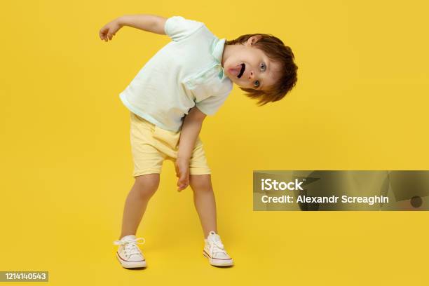 Adorable Funny Kid Listening Music And Dance Over Yellow Background Stock  Photo - Download Image Now - iStock