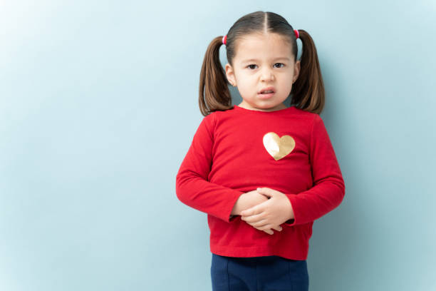 istock Little girl with a stomachache 1214142384