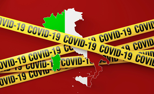 Italy map surrounded by COVID-19 imprinted tape barriers on red background. Horizontal composition with copy space. COVID-19 quarantine and pandemic concept.