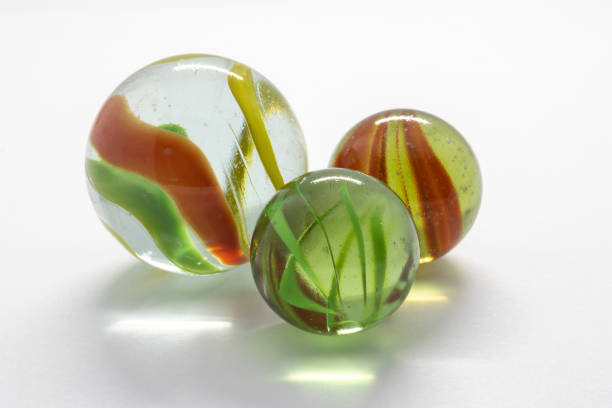 istock Colourful toy marbles against a white background 1214143909