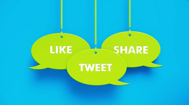 istock Green Speech Bubbles Imprinted with Like Tweet Share Text Hanging over Blue Background 1214145105