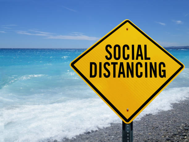 istock social distancing sign on beach 1214146219