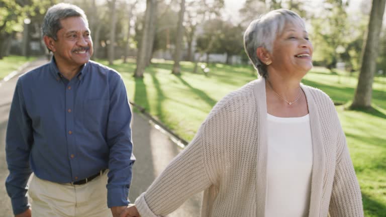 4k video footage of a happy senior couple going for a relaxing walk in the park